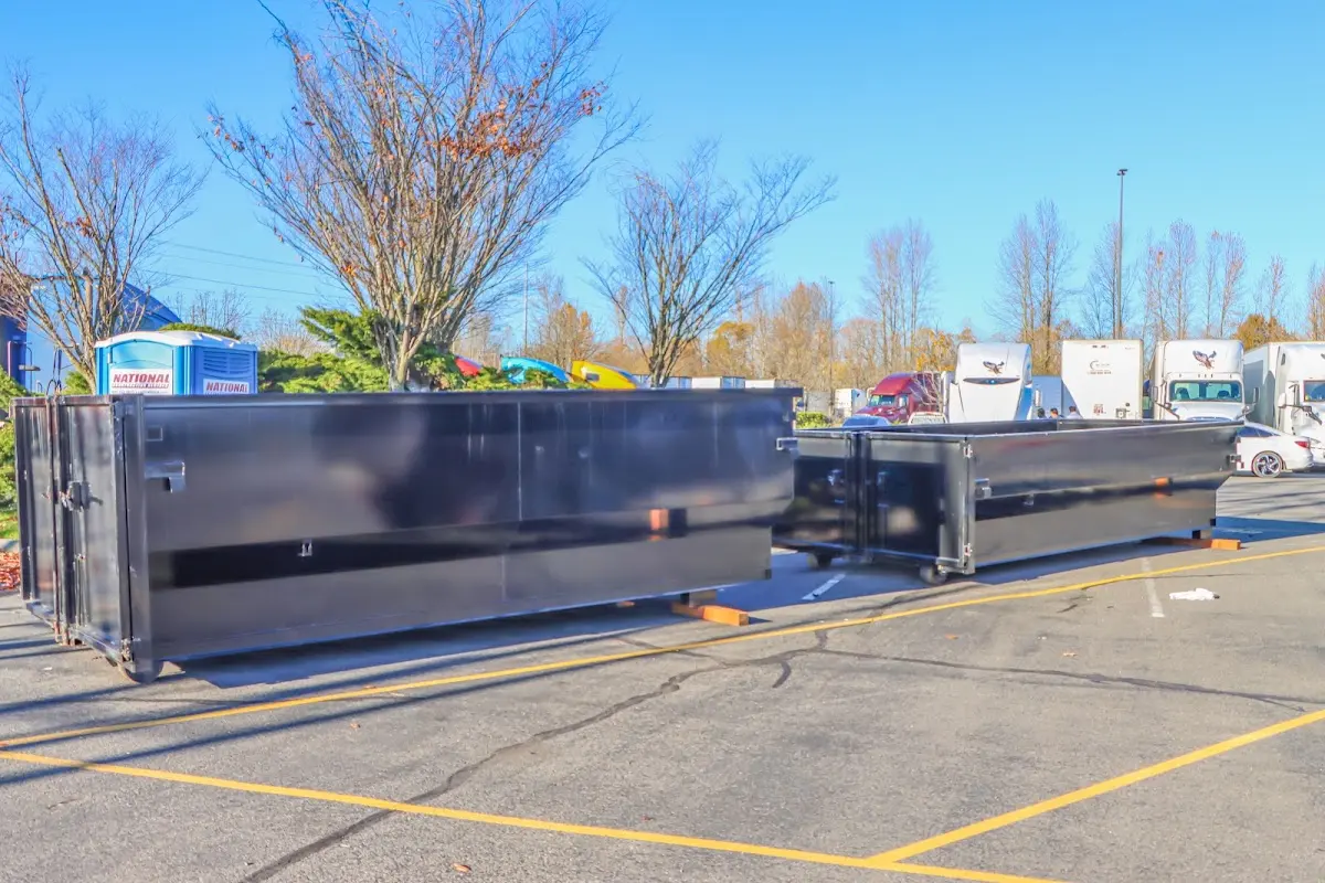 Professional dumpster rental service with roll-off container on residential driveway in New Albany